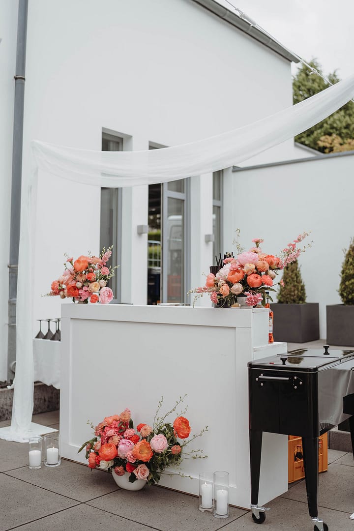 Mobile Bar mit Blumenarrangements bei einer privaten Gartenfeier auf einem Anwesen