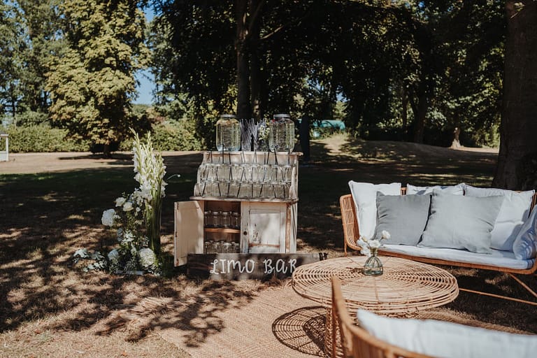 Limonadenbar und Lounge-Bereich bei einer Outdoor-Hochzeit, Teil einer durchdachten Hochzeitsplanung und Partyplanung.