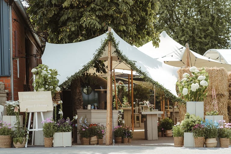 Zelthochzeit auf privatem Hof mit Naturdeko, Stauden und Foodtruck-Bereich – individuell geplante Private Estate Wedding mit hochwertiger Hochzeits- und Eventplanung